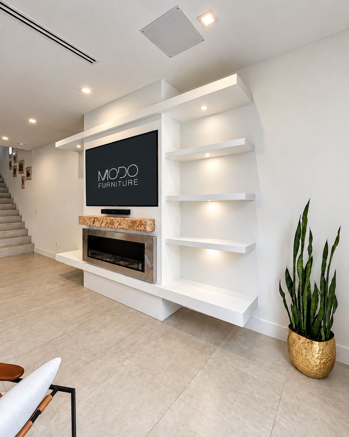 White custom TV wall unit with lit floating shelves and a linear fireplace under a wall-mounted TV