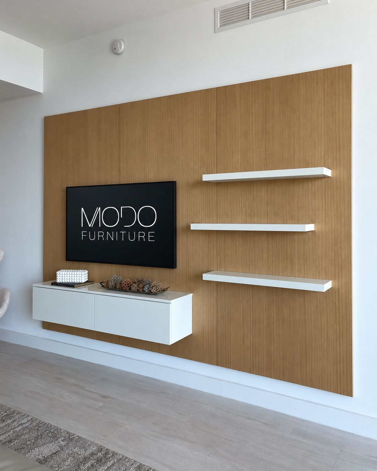 Oak veneer TV wall panel with three floating white shelves and a floating white cabinet
