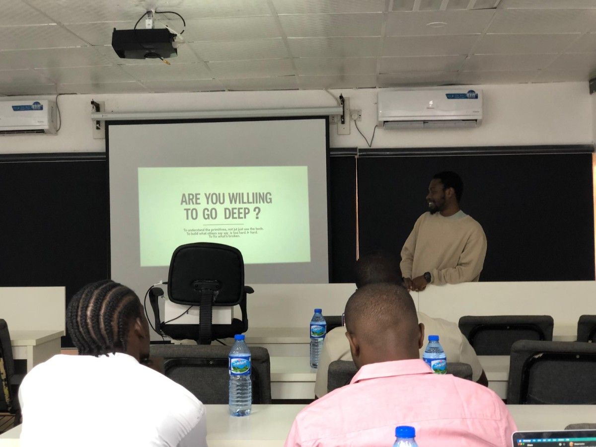 A candid shot of Bernard Parah smiling at the front, with attendees.