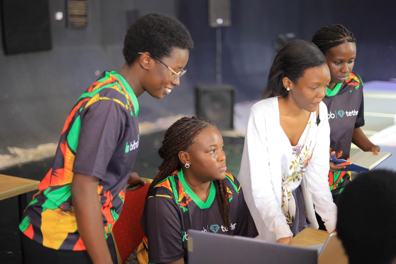 Four females attendees at the Bitnob Developer Event in Uganda 2025 staring on  a computer screen