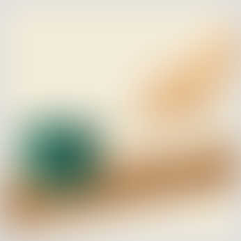 A hand pulls a green block with a rope across a wooden surface, demonstrating a contact force in action.