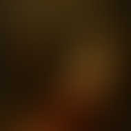 Othello cradles the lifeless Desdemona in a dimly lit room, depicted in an oil painting with warm, dramatic tones.