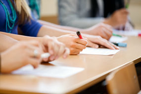 A close-up of students sitting a examination.