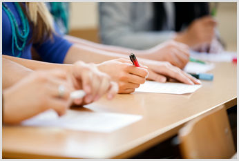 A close-up of students sitting a examination. A close-up of students sitting a examination.