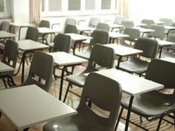 A close-up of the chairs and desks in an empty classroom.