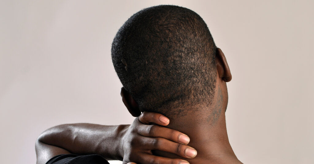 painfully holding neck