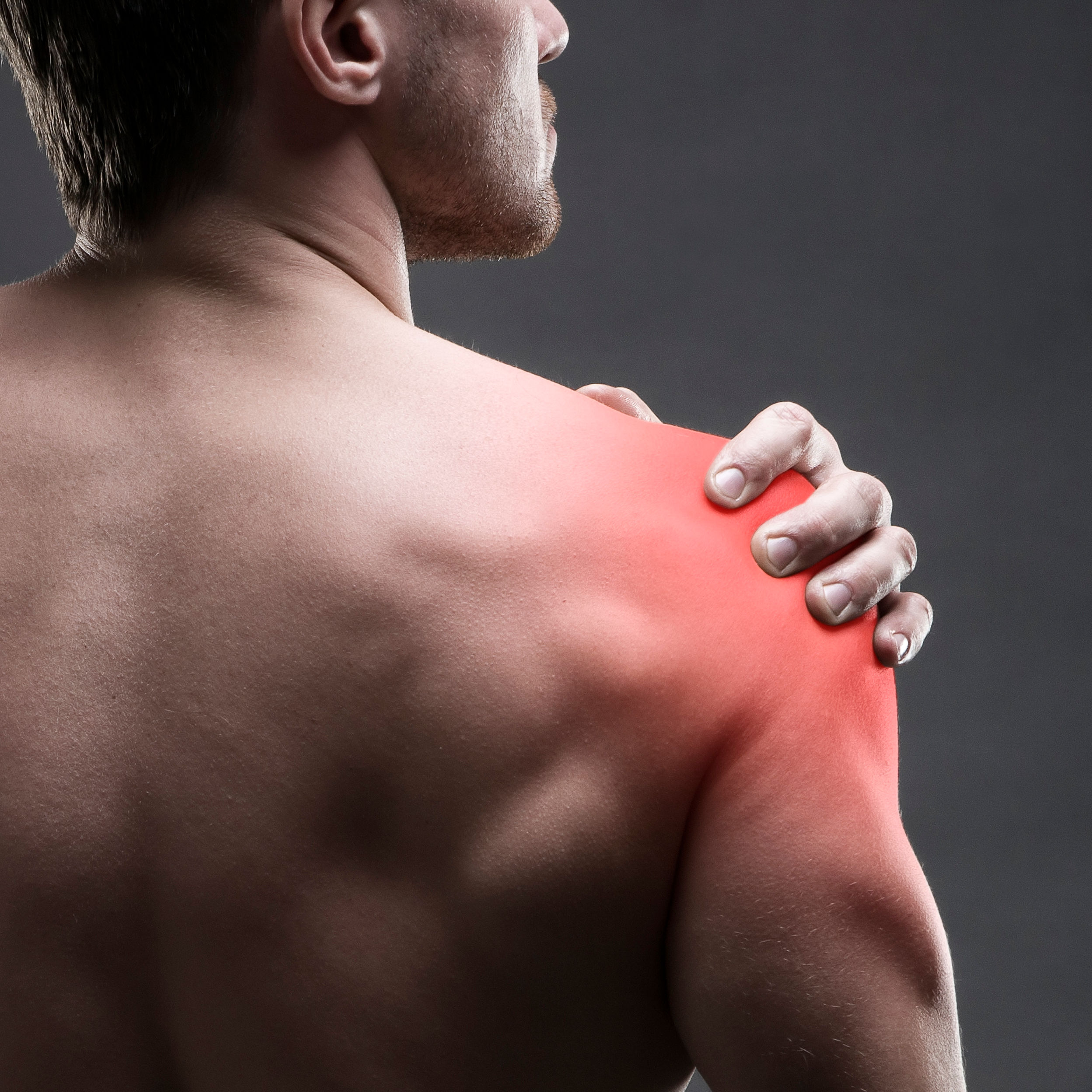 Pain in the shoulder. Muscular male body.
