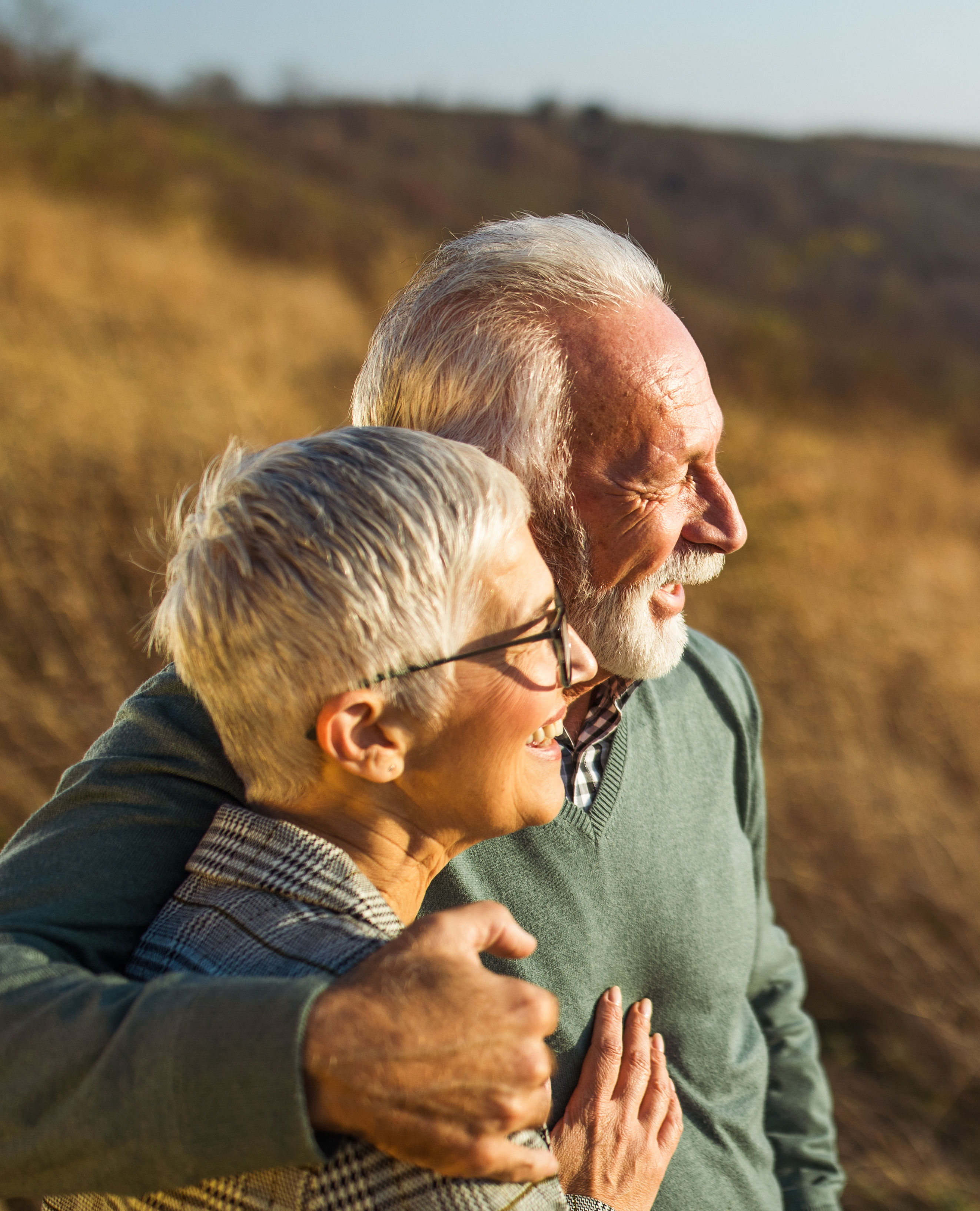 Embraced senior couple enjoying in autumn day on a