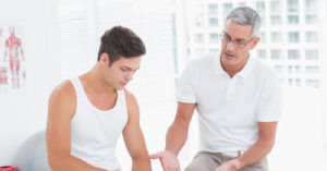 chiropractor helps patient rehab