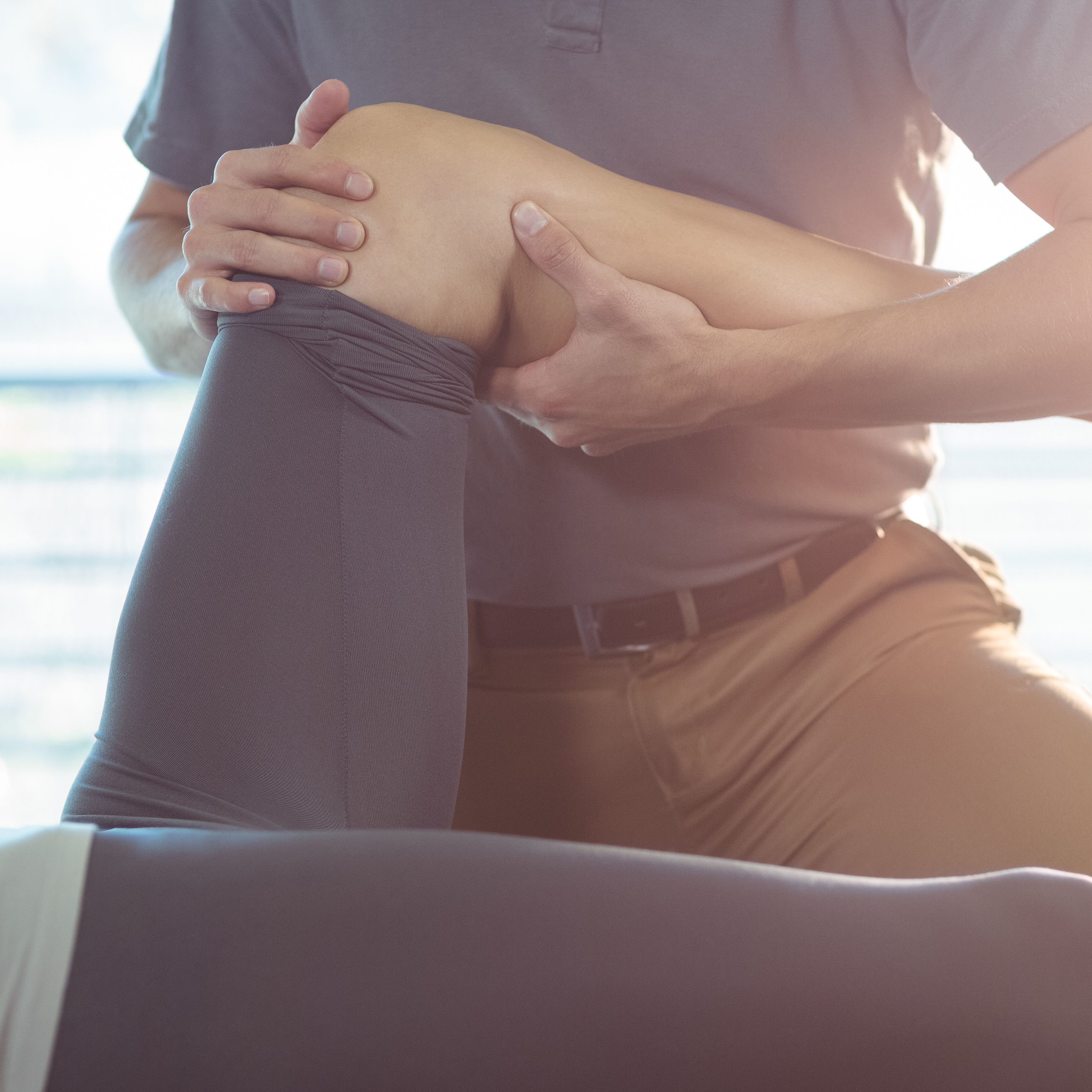 Physiotherapist giving knee therapy to a woman