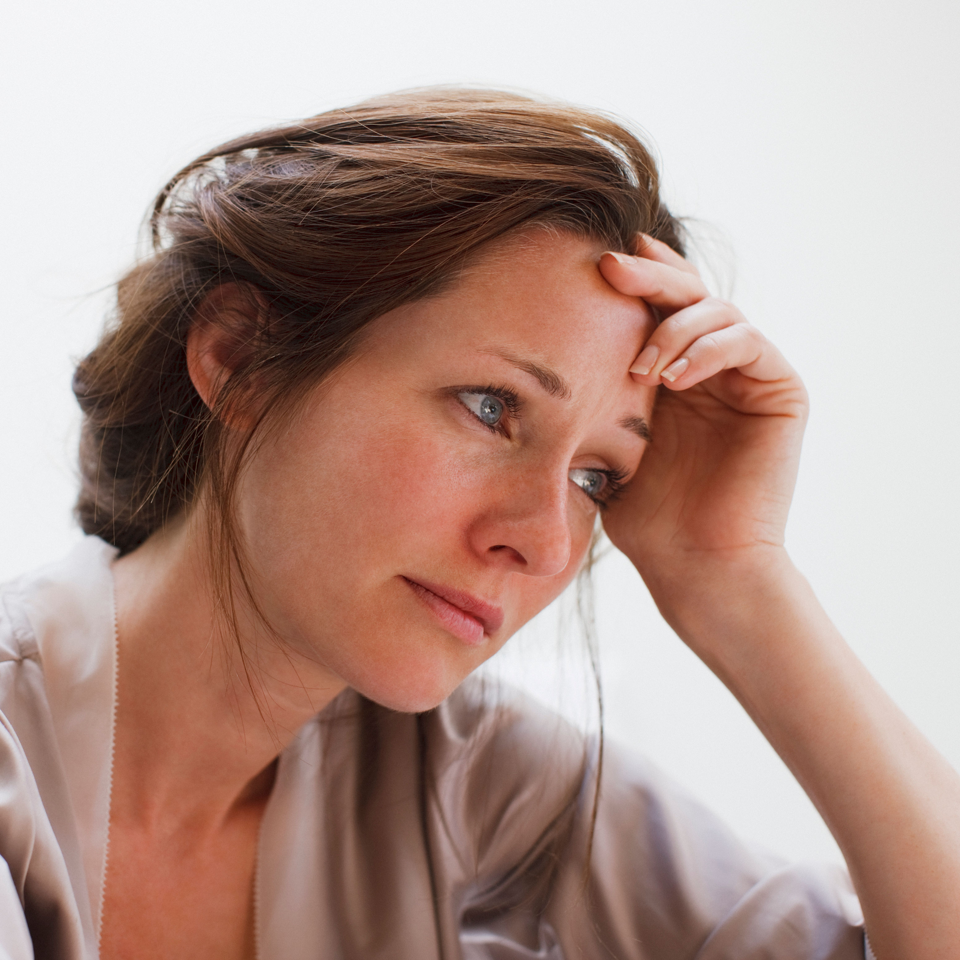 Depressed woman with head in hands