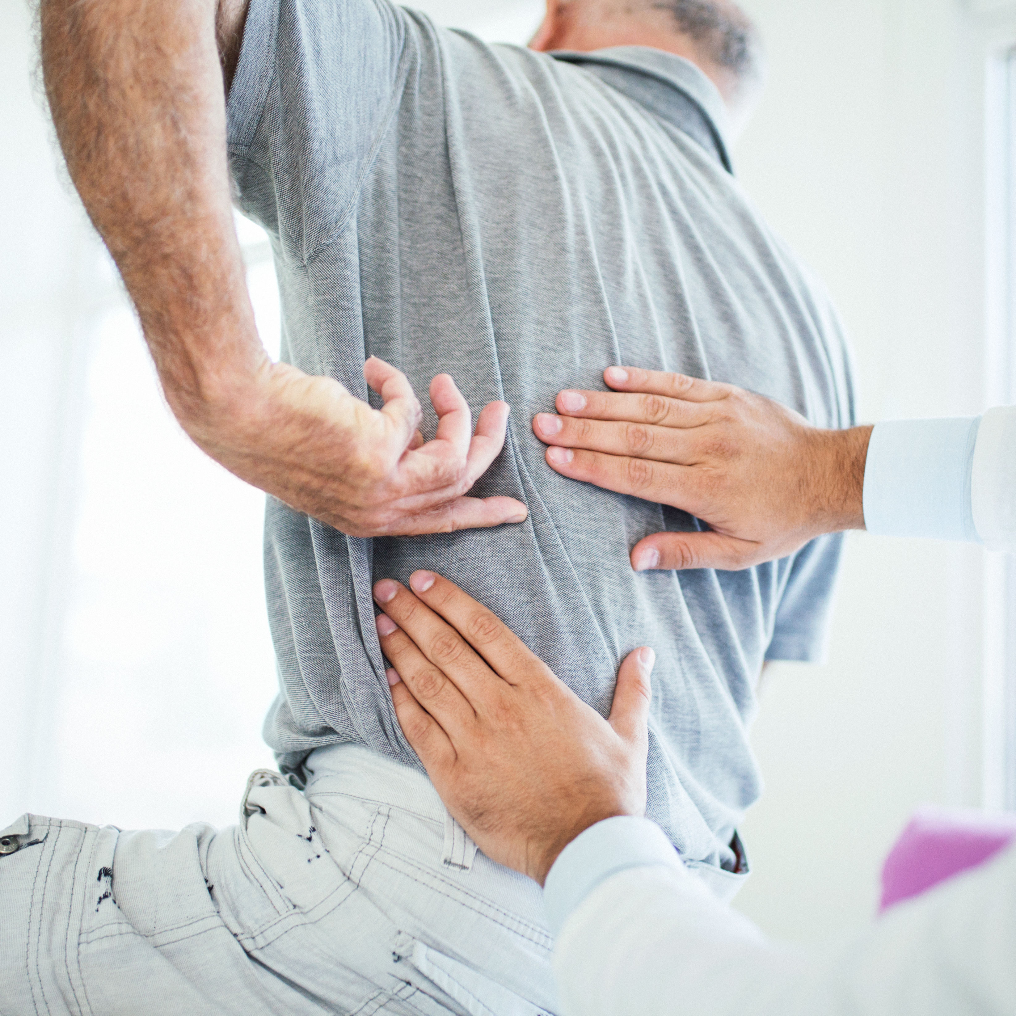 doctor evaluating patient's back pain