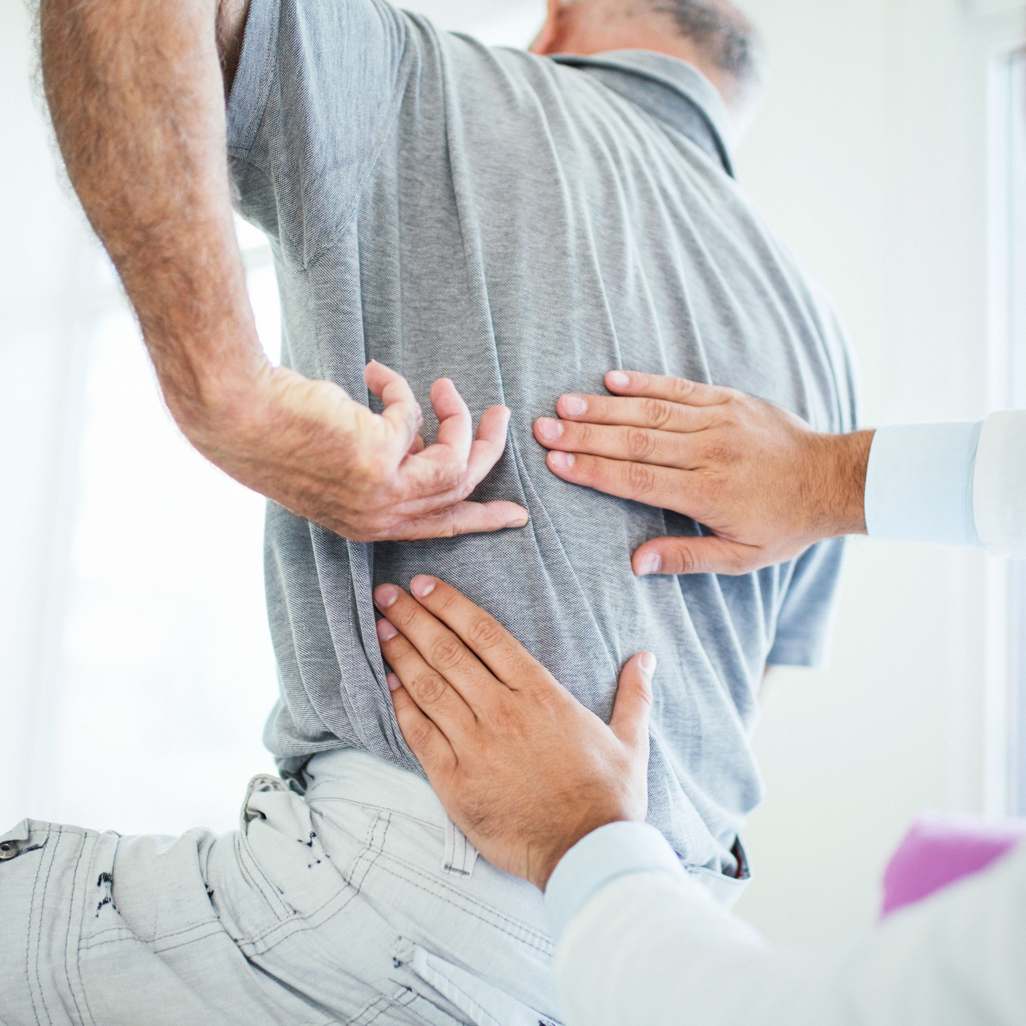 doctor evaluating patient's back pain