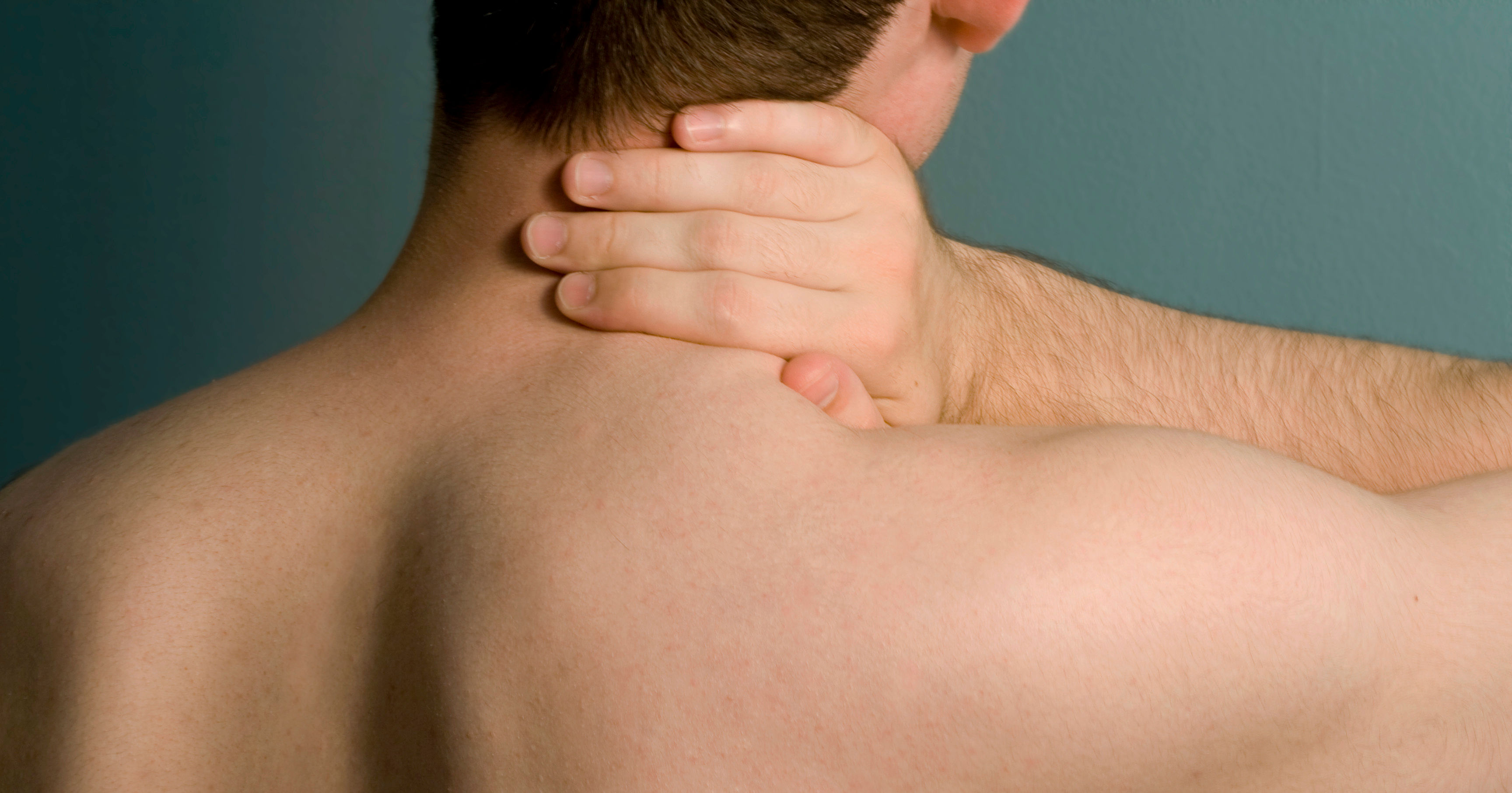 man holding side of his neck