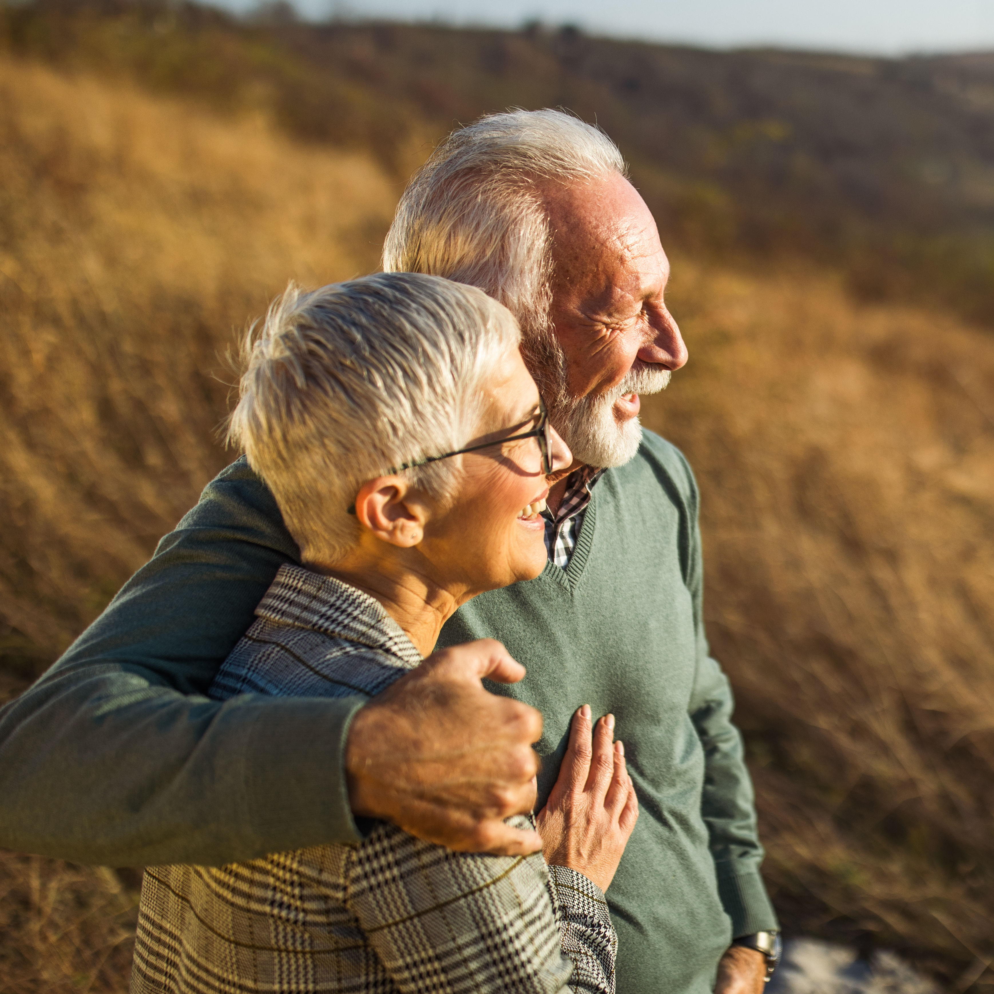 Embraced senior couple enjoying in autumn day on a