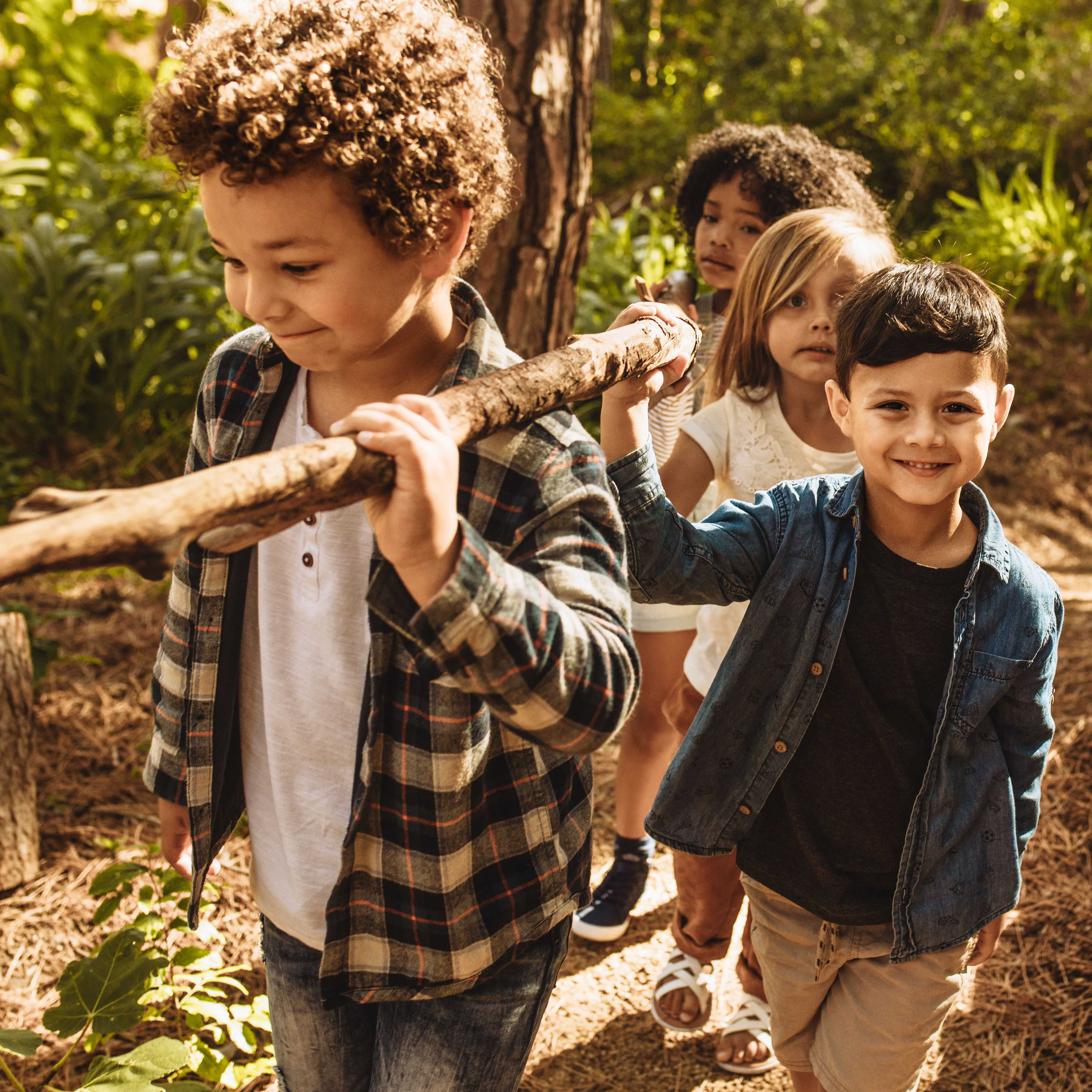 Kids making camp in forest