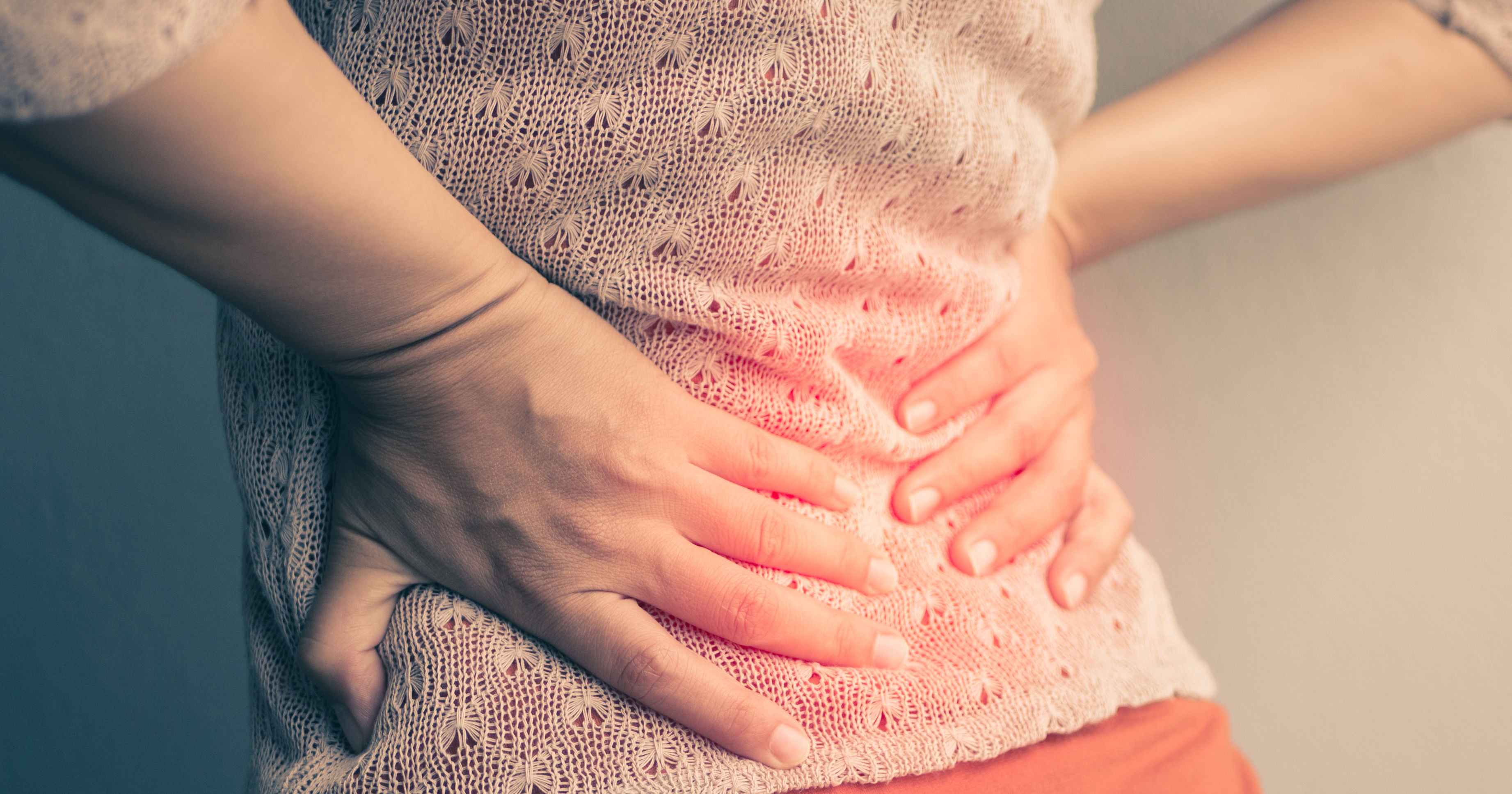 Closeup woman with hands holding her waist back in