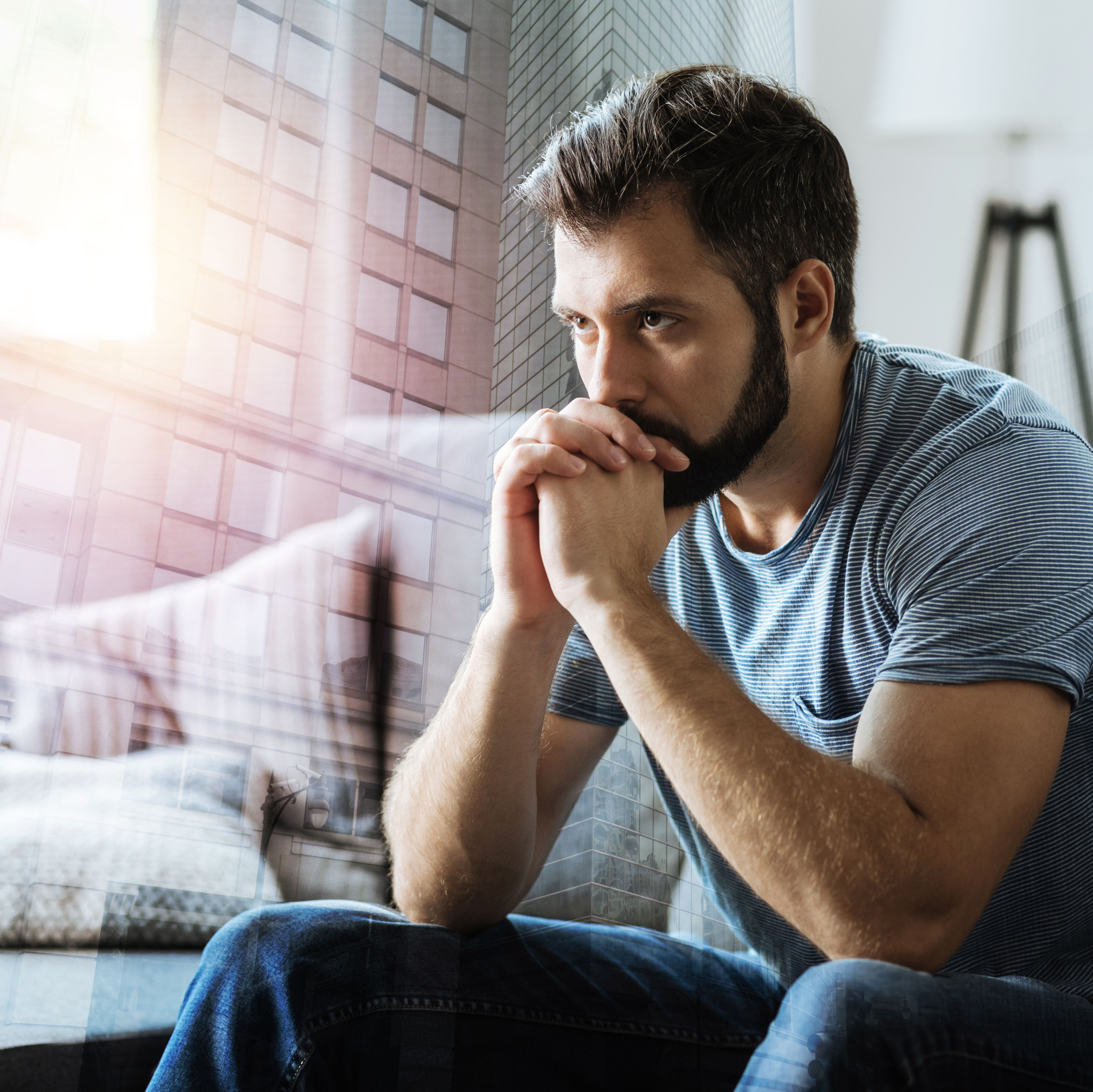Thoughtful serious man sitting and thinking