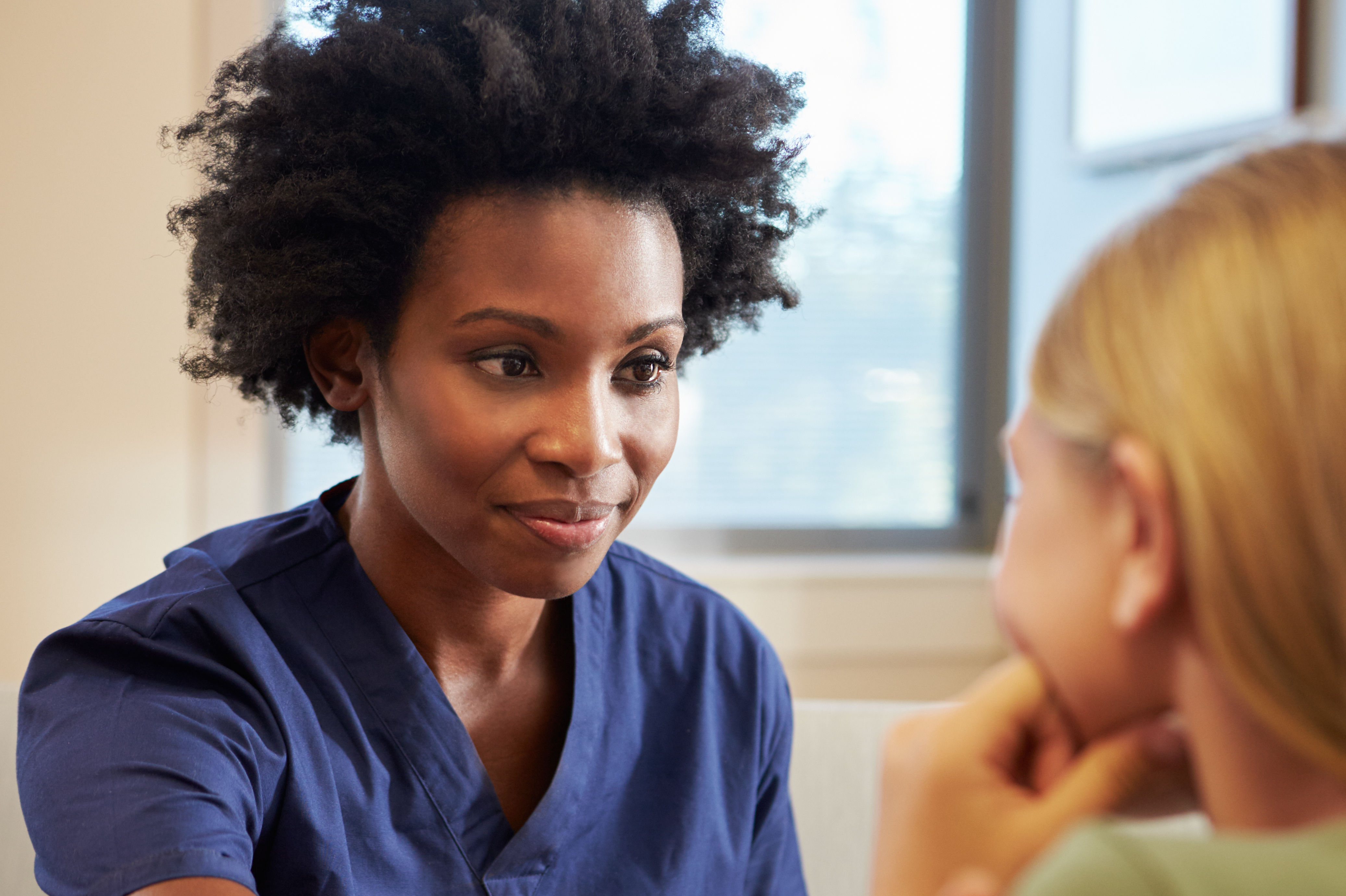 Nurse Treating Teenage Girl Suffering With Depress