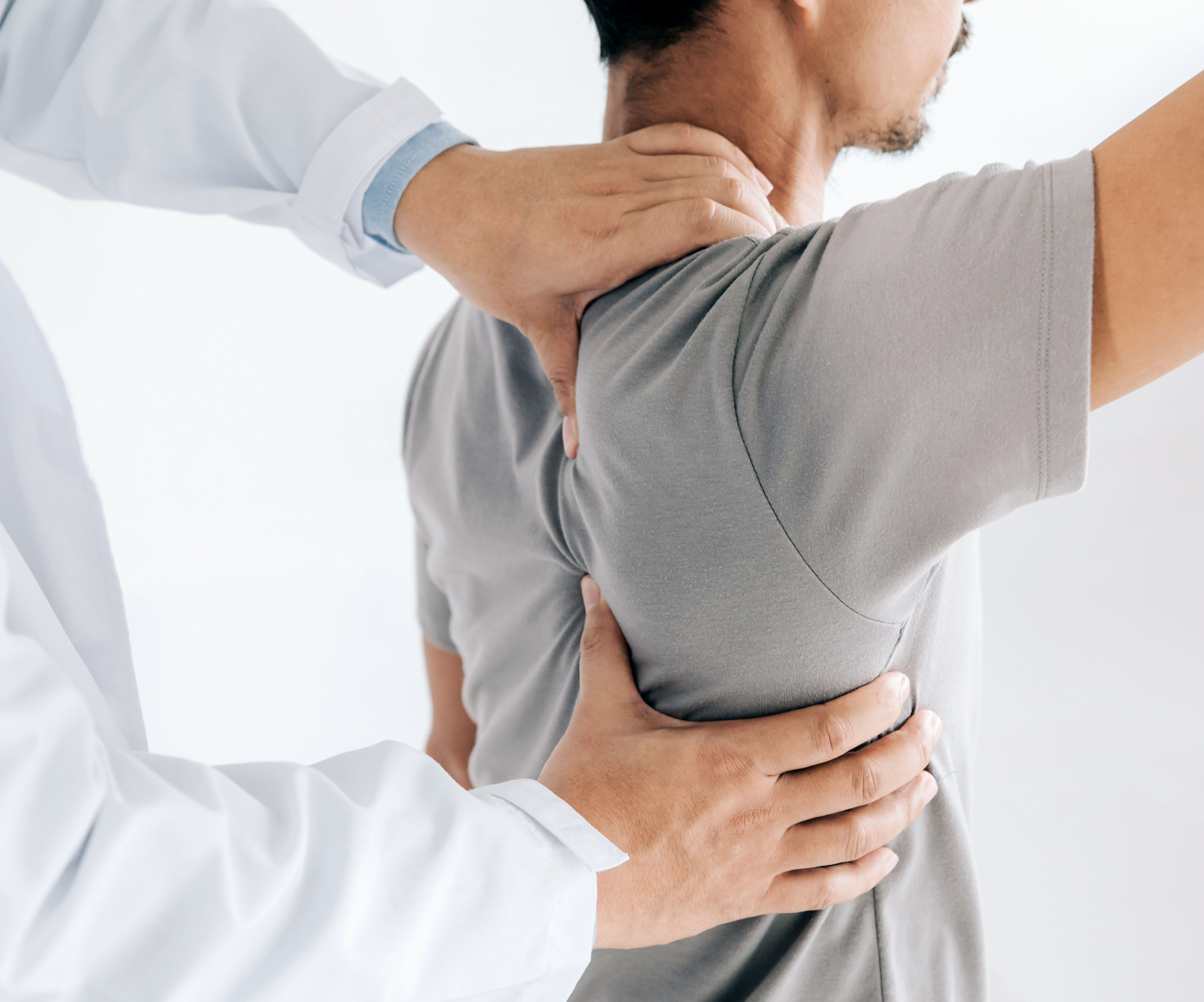 Physiotherapist doing healing treatment on mans ba