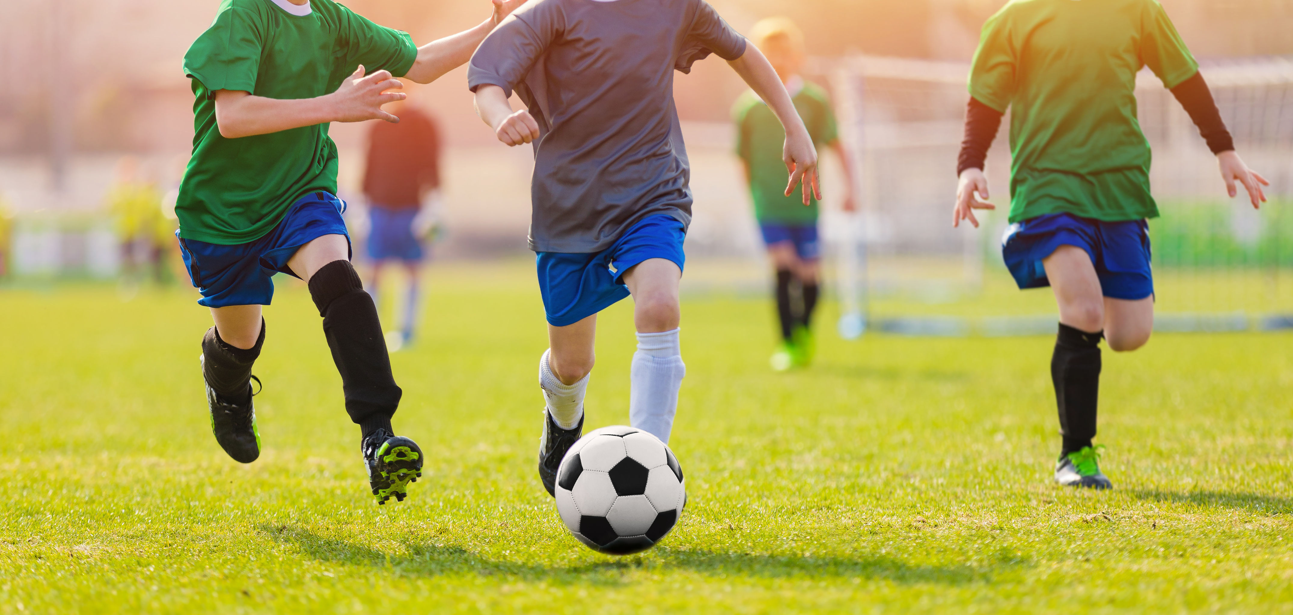 Running Soccer Football Players During the Sunrise
