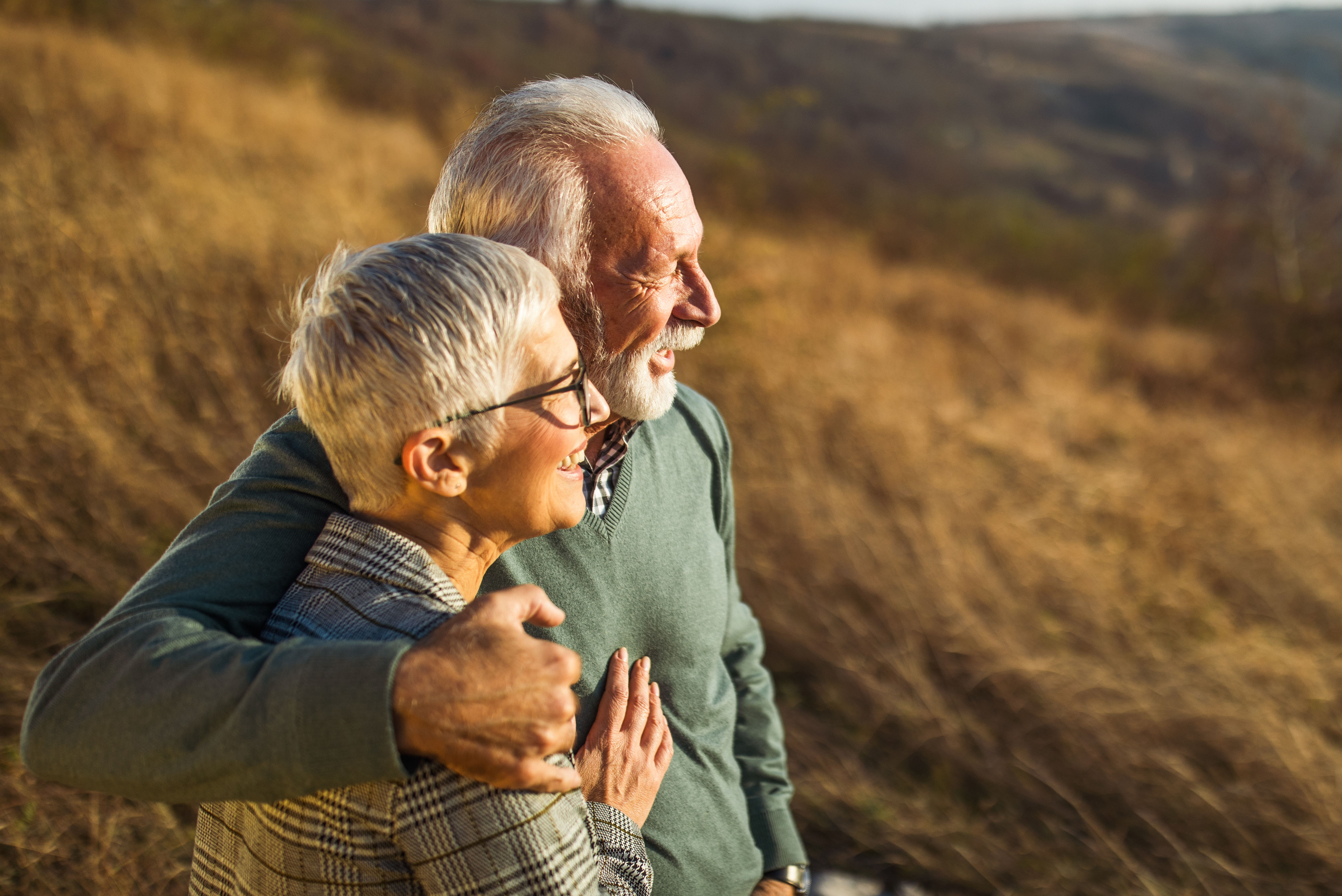 Embraced senior couple enjoying in autumn day on a