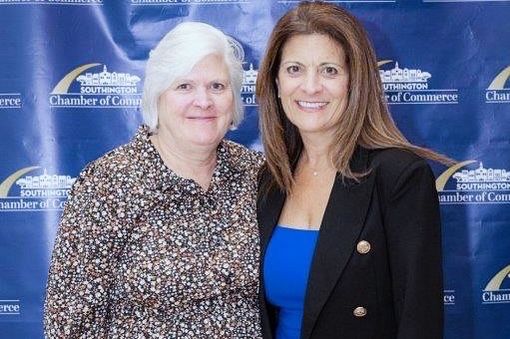 award winning woman taking a photo with another woman