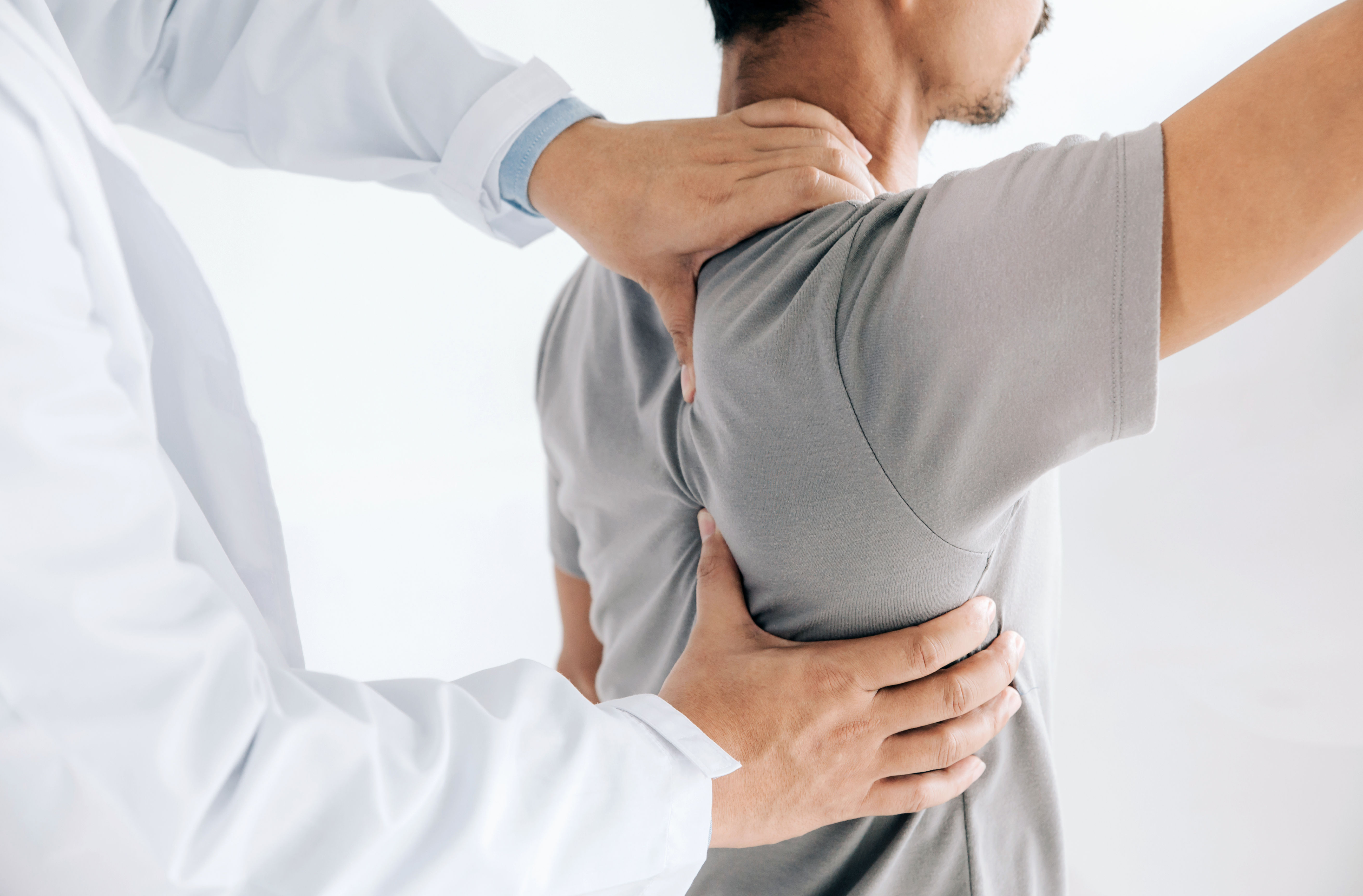 Physiotherapist doing healing treatment on mans ba