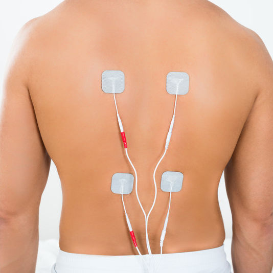 Electrical Muscle Stimulation Pads applied to the back.