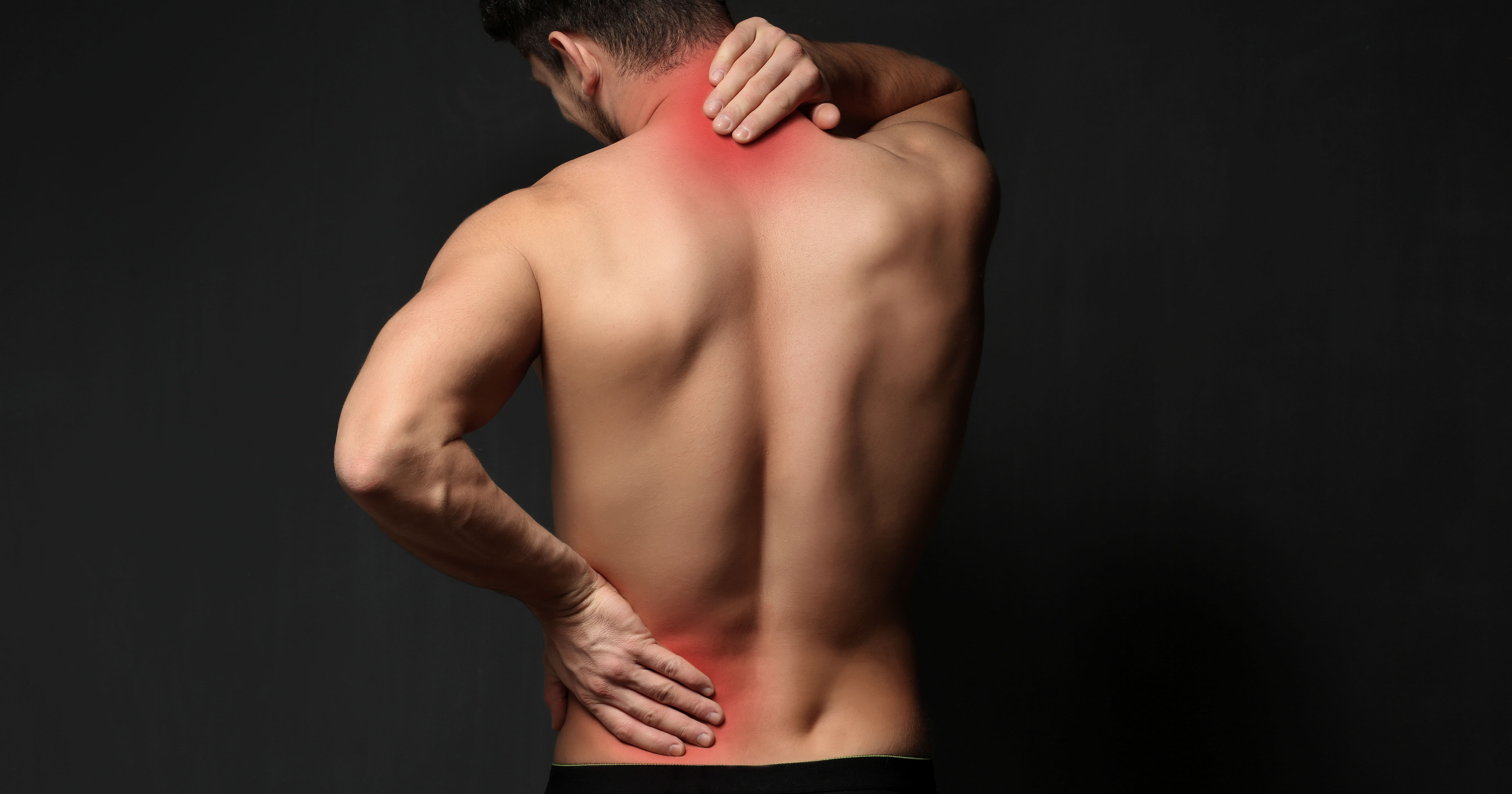 from the back and waist up of a fit young white man with hands on low back pain and neck pain glowing red