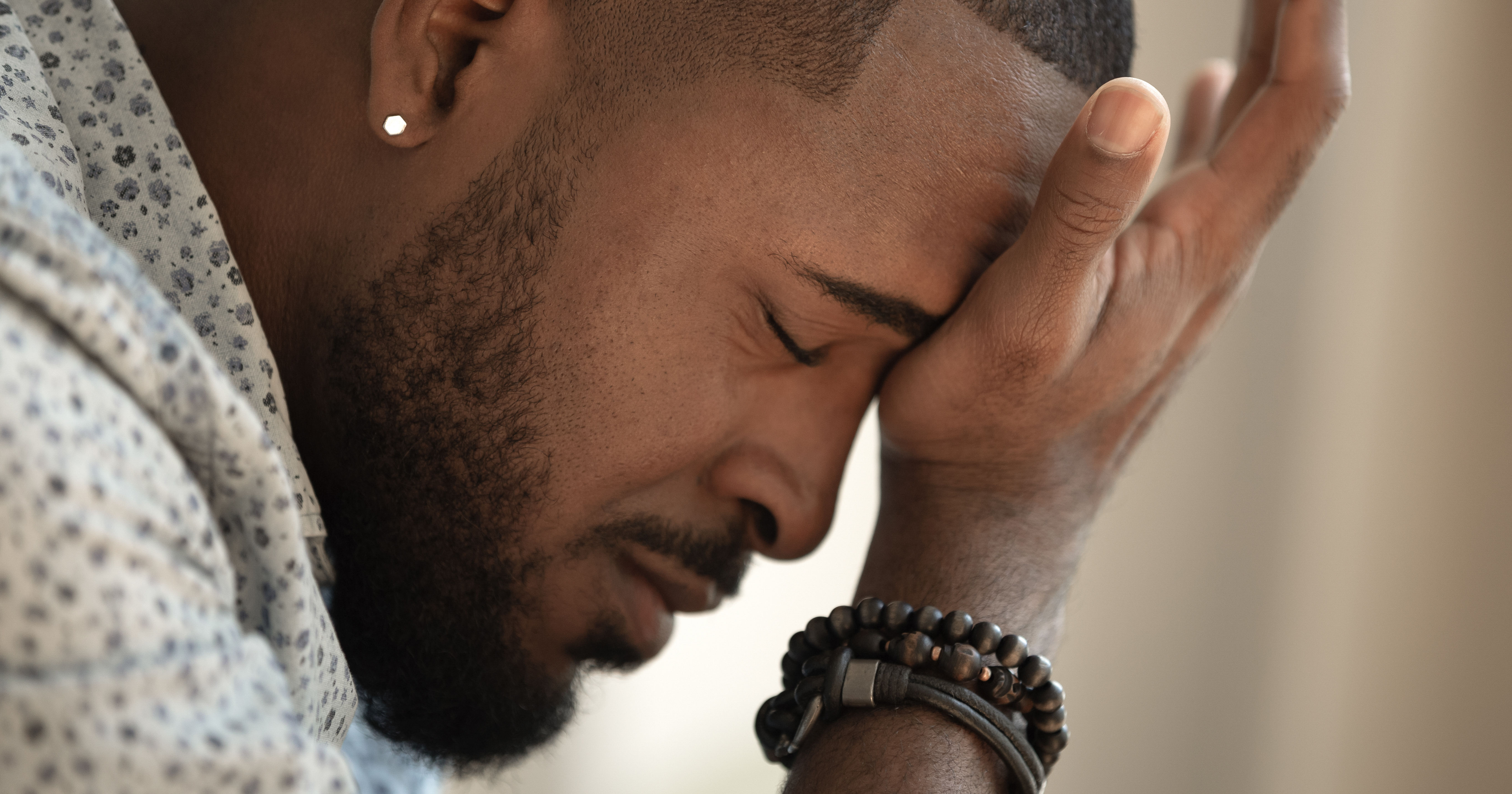 Upset stressed young african american man coping w