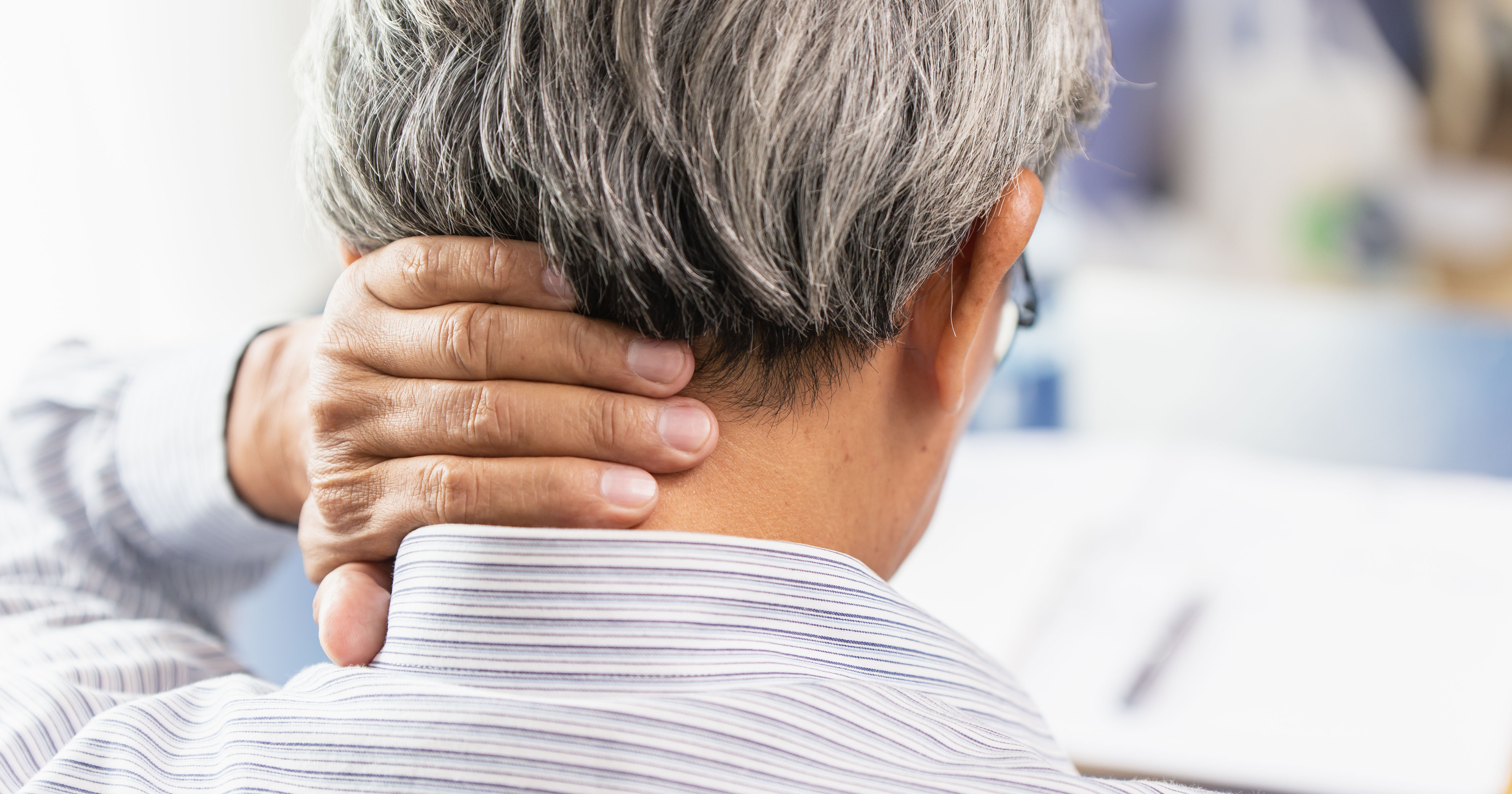 back of the neck elderly male left hand on back of neck