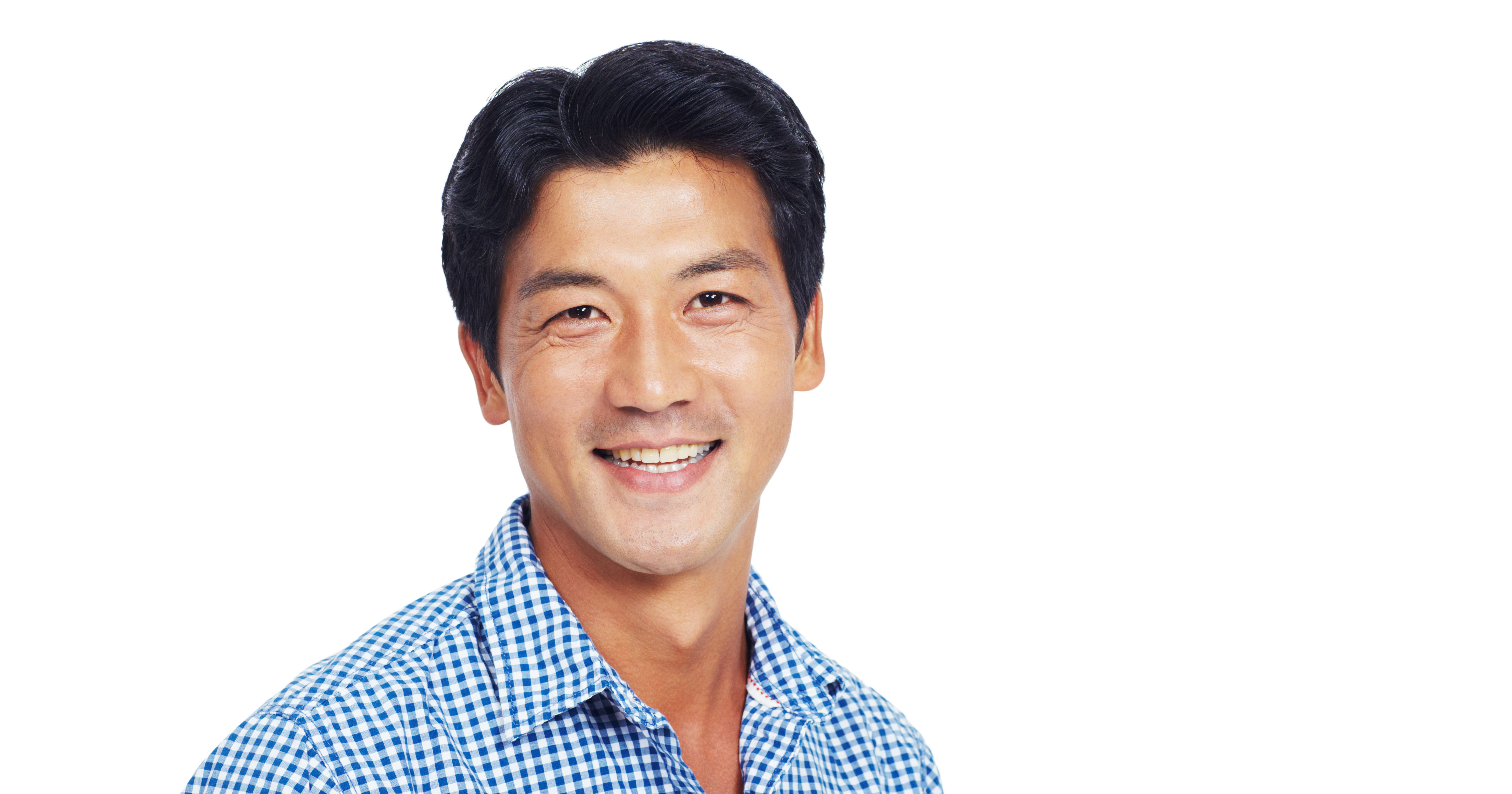 Smiling man in blue and white shirt over a white b