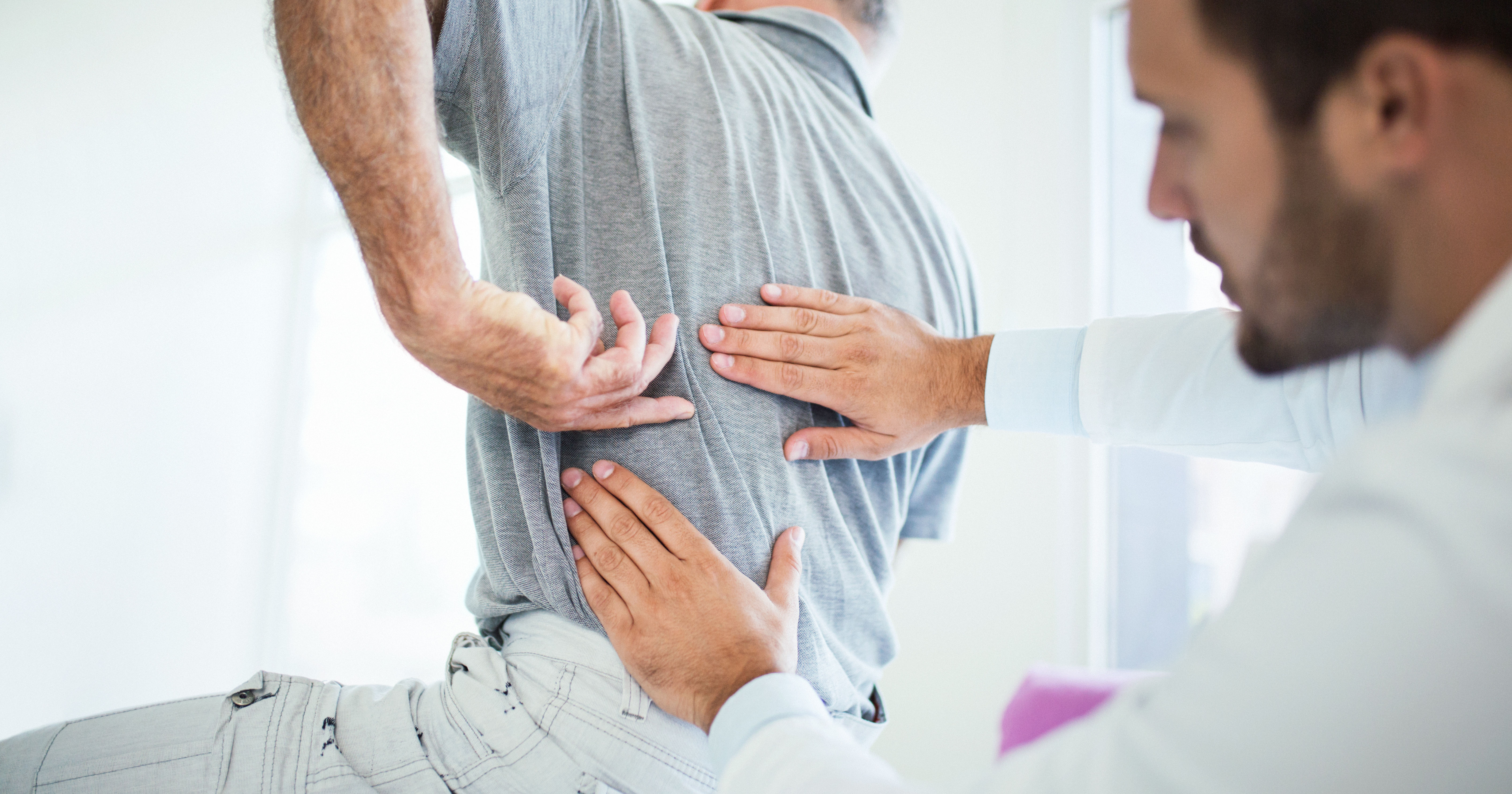 doctor evaluating patient's back pain