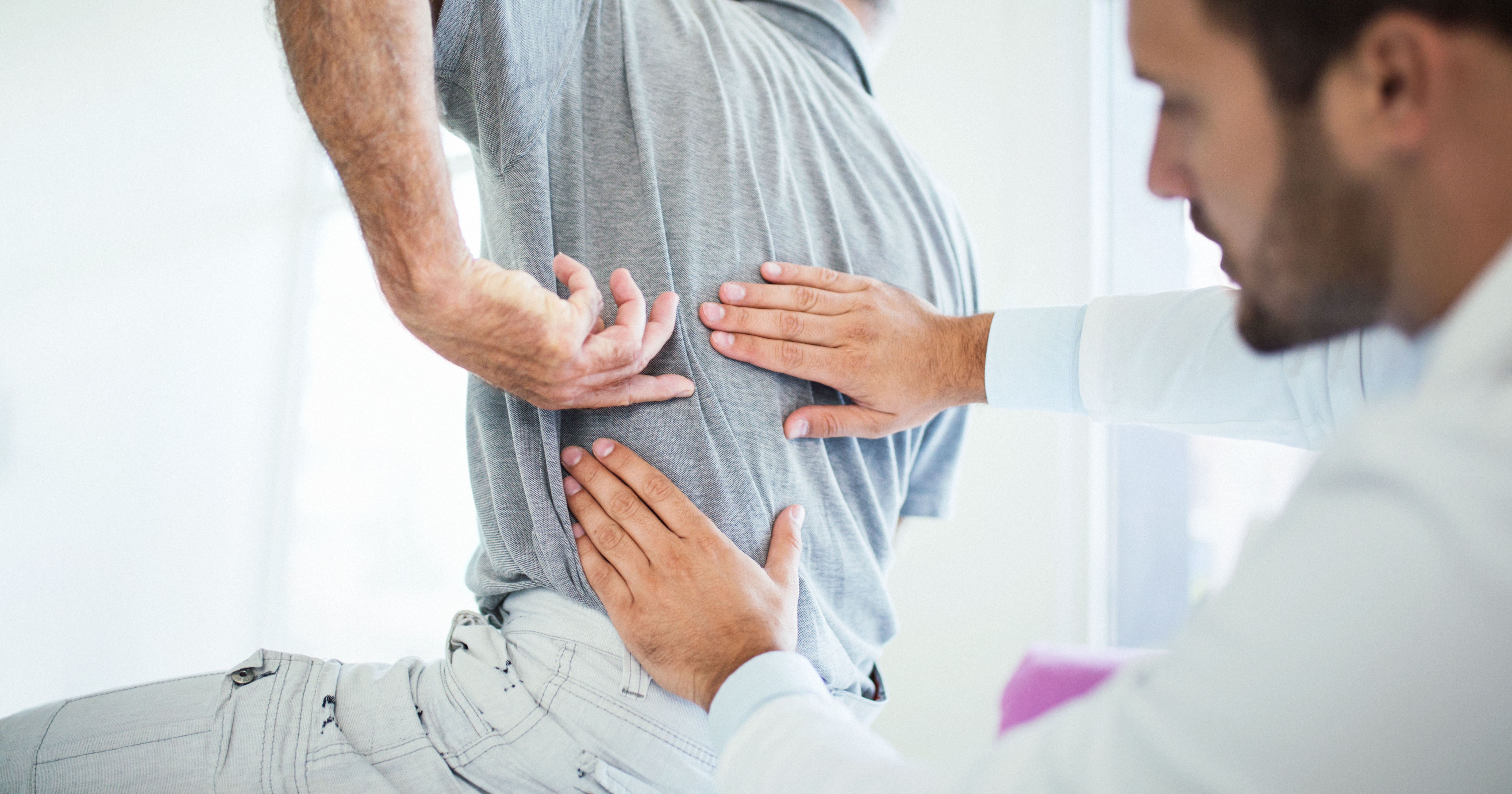 doctor evaluating patient's back pain