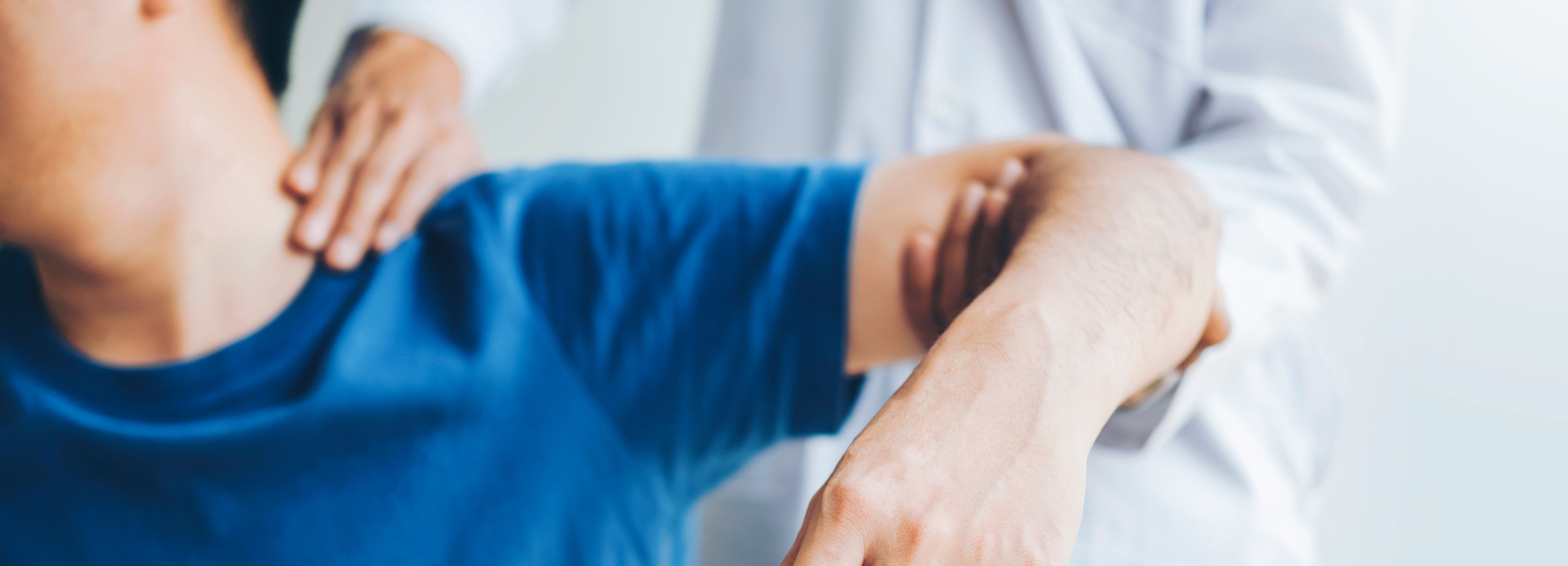 Doctor consulting with patient about shoulder pain