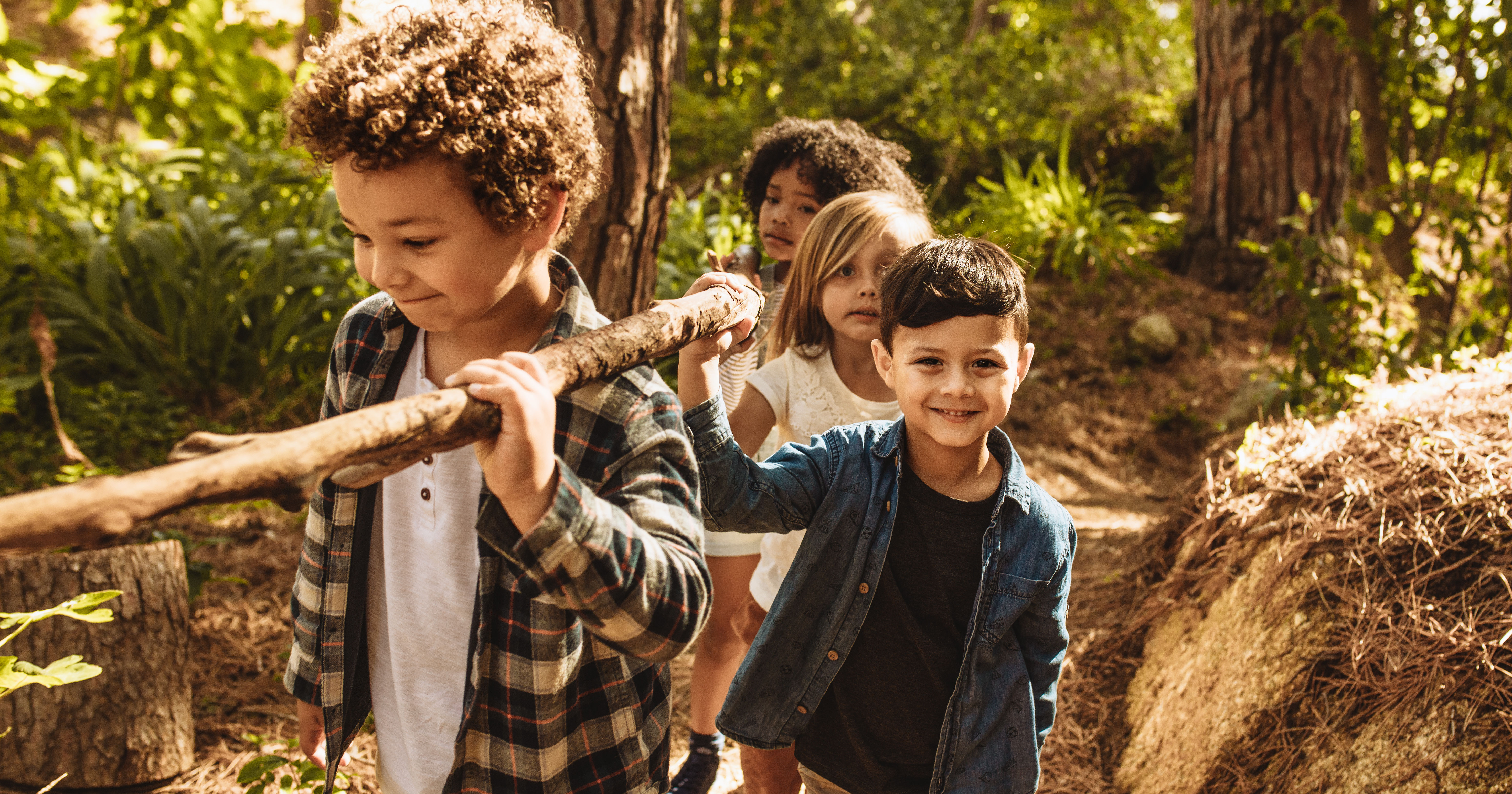 Kids making camp in forest