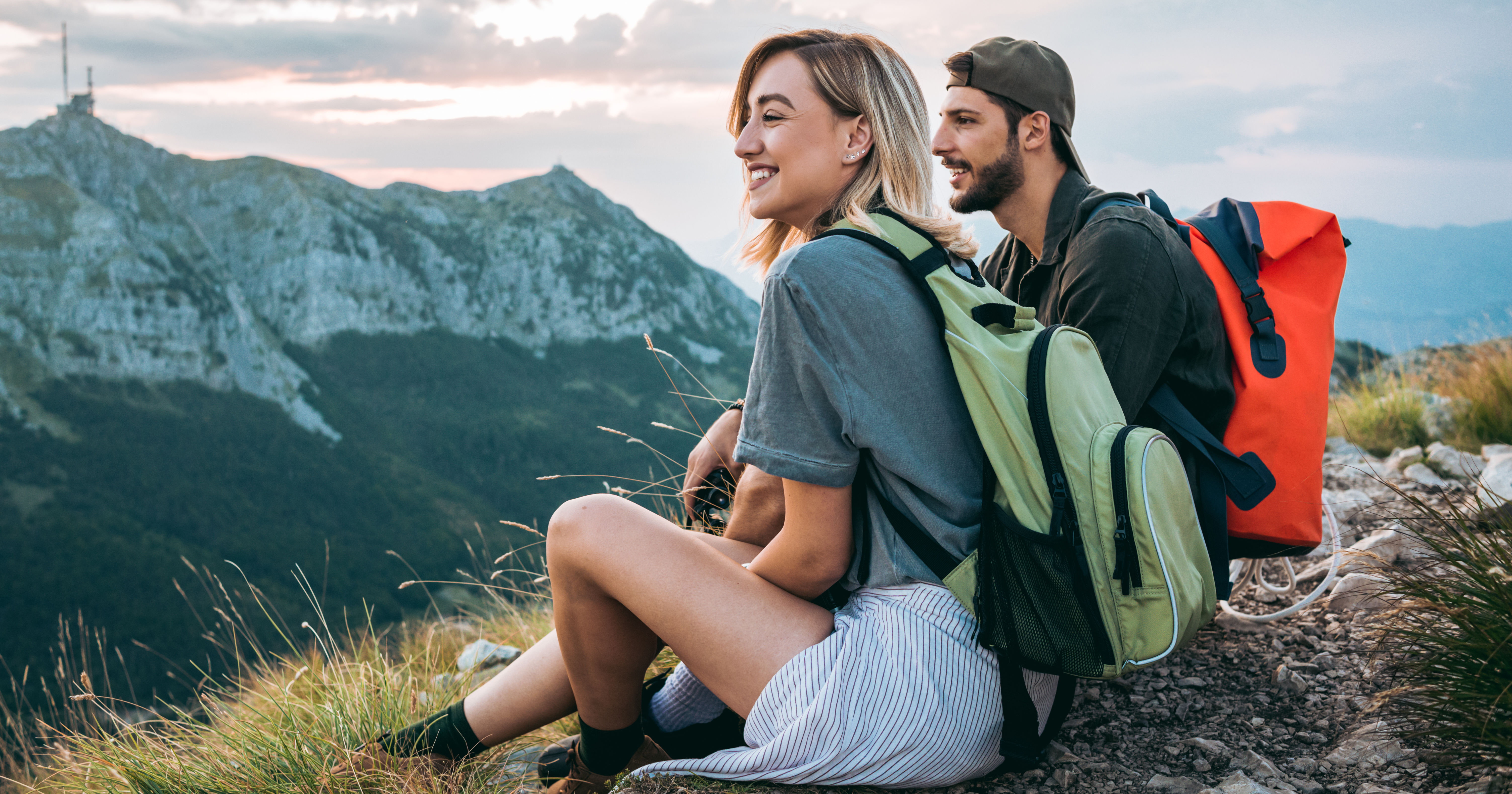 beautiful young couple relaxing after hiking and t