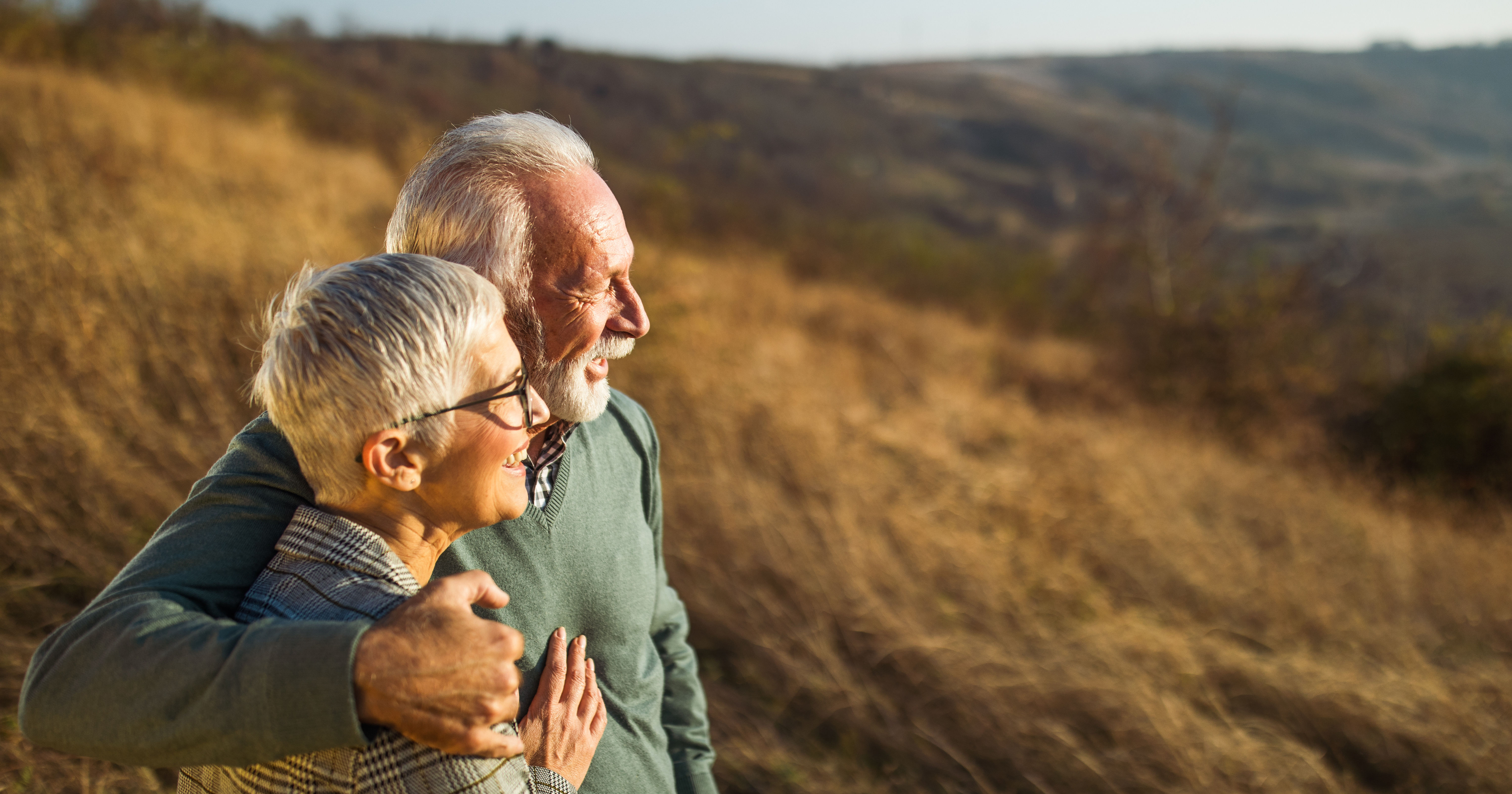 Embraced senior couple enjoying in autumn day on a
