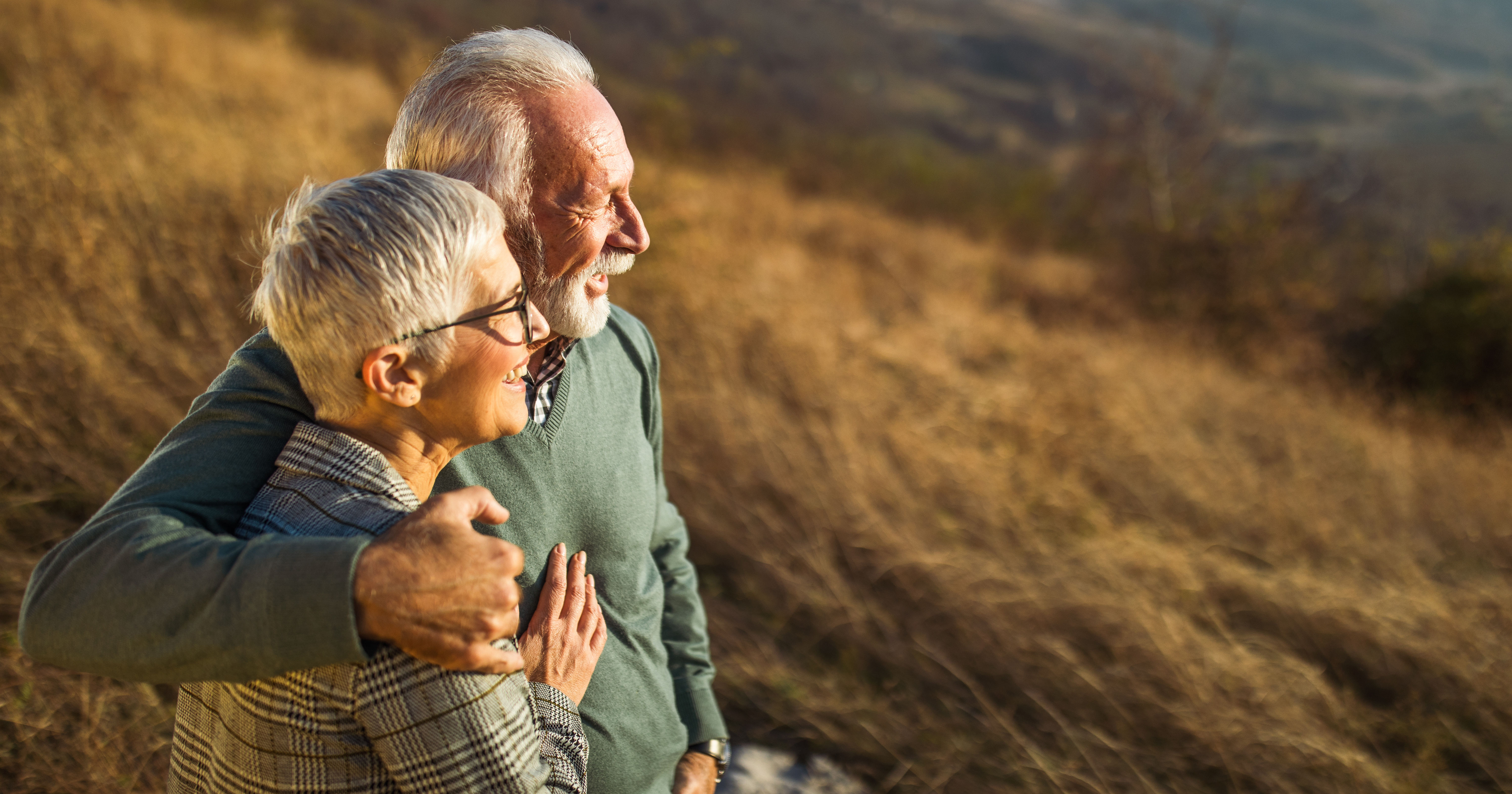 Embraced senior couple enjoying in autumn day on a