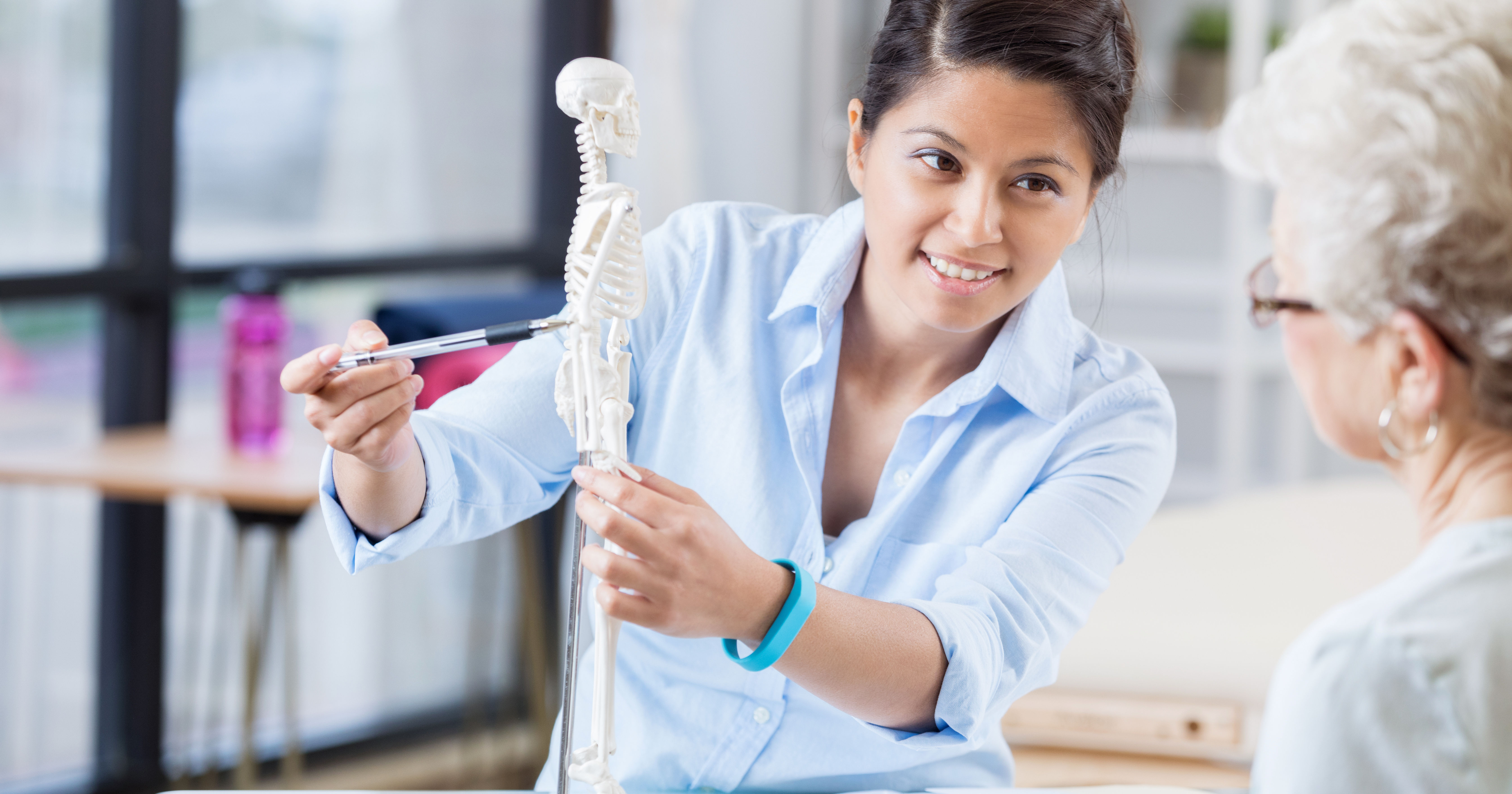 Young chiropractor explains treatment plan to seni