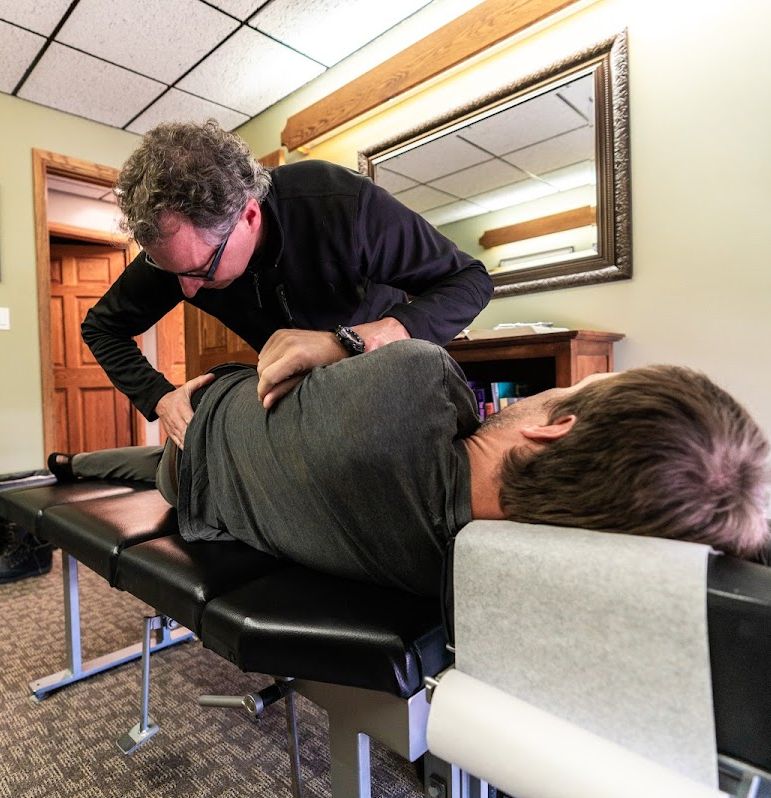Dr. Cole McMillan performs back adjustment