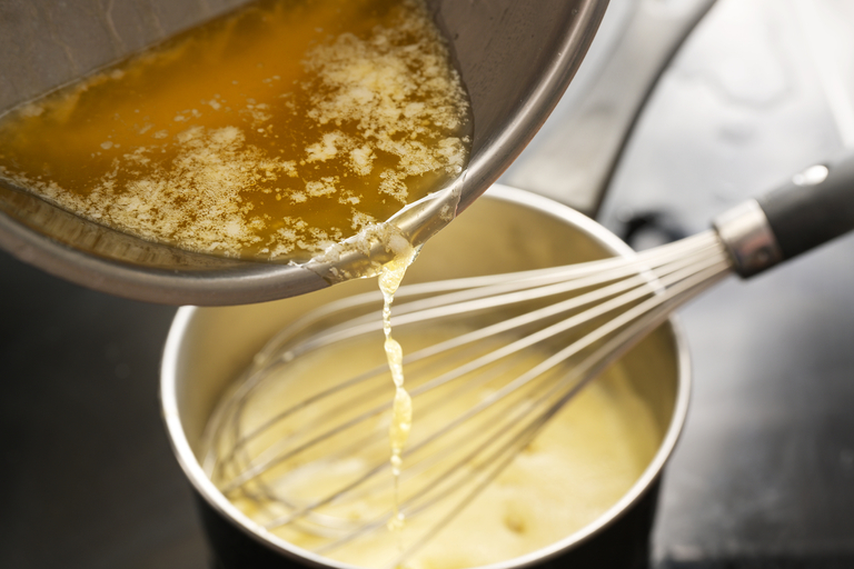 The Chef Mixes the Sauce in a Saucepan Using the Whisk. Master