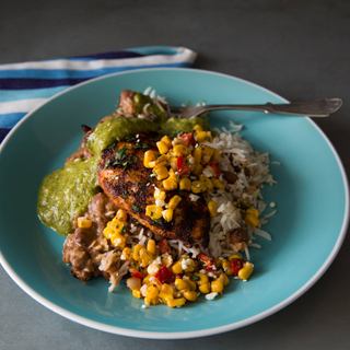 blue plate with grilled chicken breast, rice salad and corn succotash 