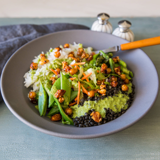 green curry vegetable bowl with white rice, lentils and coconut dressing