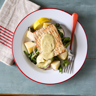 white plate with roasted salmon fillet with honey mustard sauce, steamed potatoes, asparagus and spinach