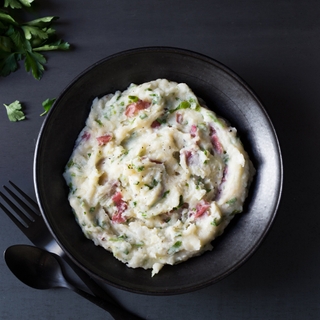 Plate of Horseradish Crushed Red Potatoes on. dartk surface