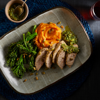 honey mustard pork tenderloin with broccolini and sweet potato mash on a rectangular dinner plate