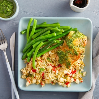 square blue plate with pan-seared salmon, confetti rice, green beans and mint pesto