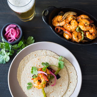 shrimp fajitas on white corn tortillas with pickled red onions and fresh cilantro